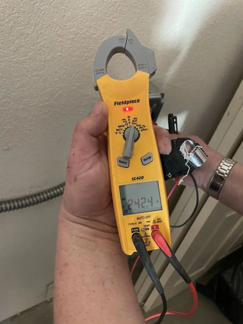 Voltage testing with clamp meter during Recessed Lighting Installation in Dixon